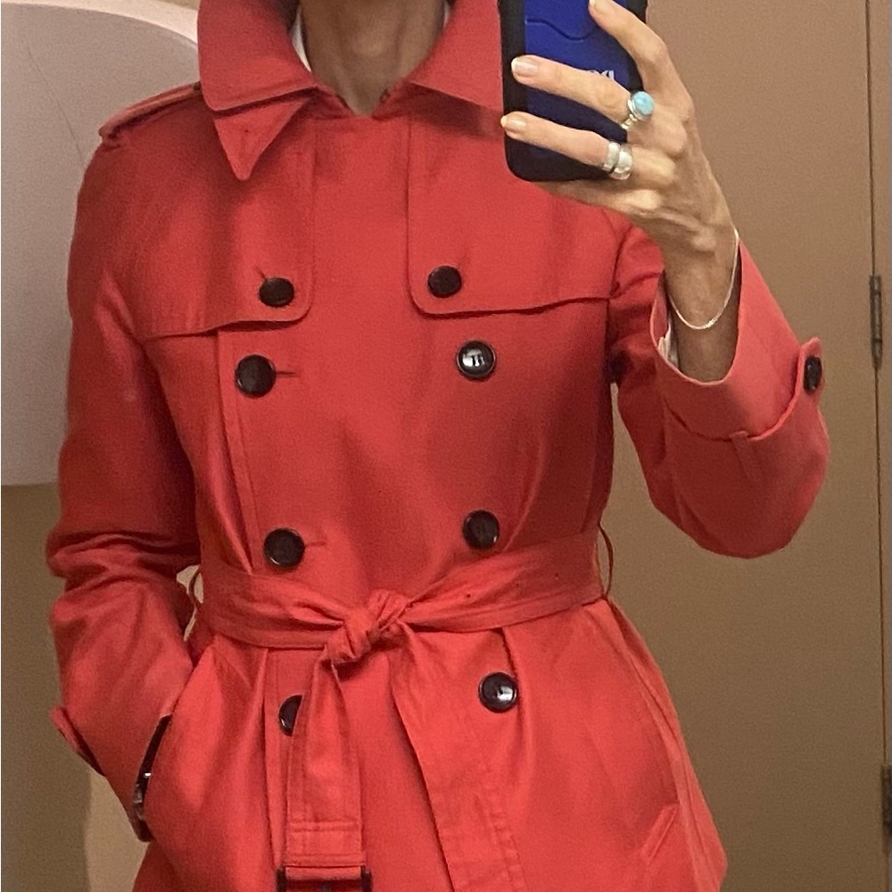 This is a salmon coloured short trench.  Size is  M but I would say SM - Med.